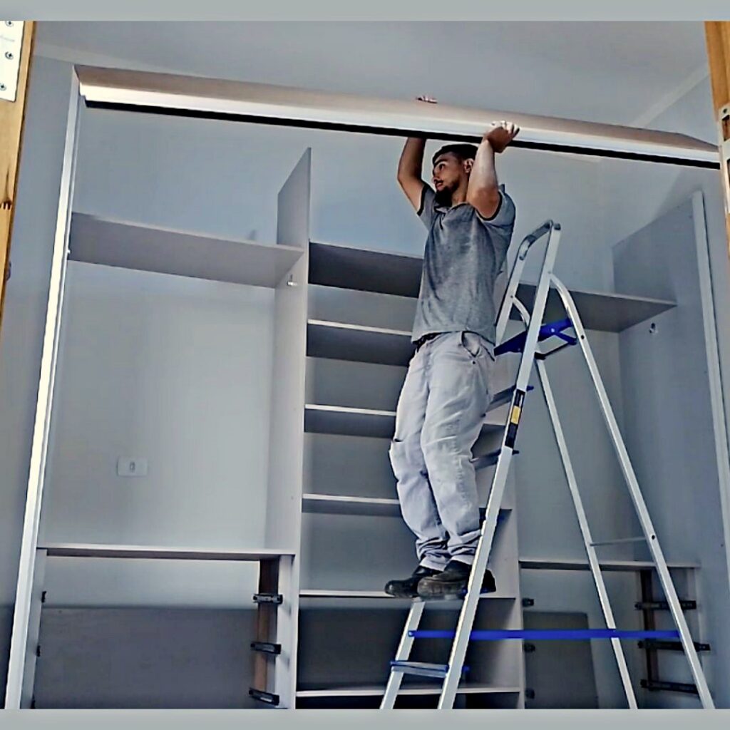 Uma imagem real de um montador de móveis profissional montando um guarda roupa